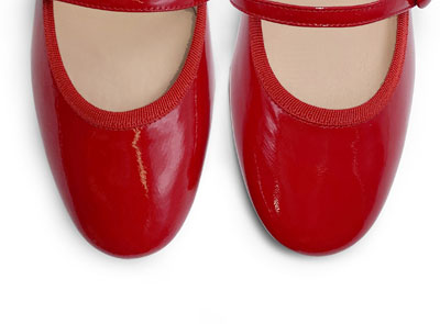 Red patent leather ballet flats with strap and heel