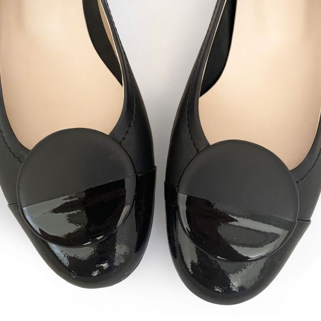 Black leather ballet flats with black patent toe and stud