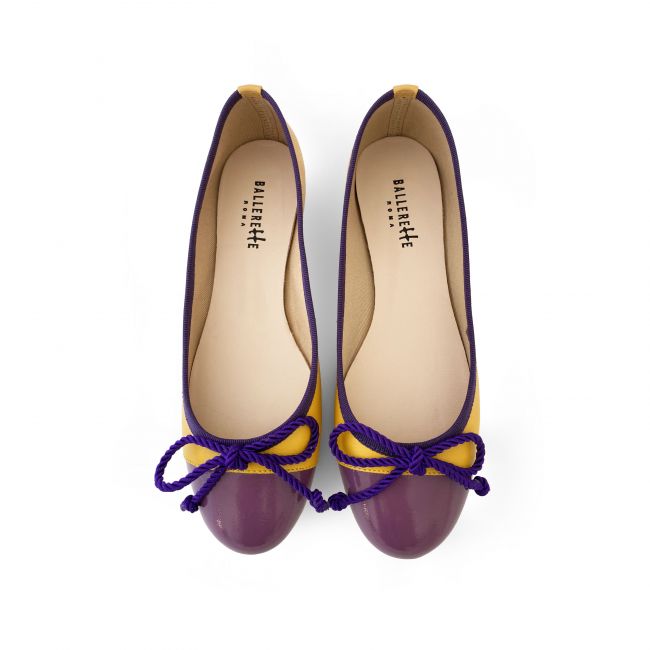 Yellow leather ballet flats with purple toe and bow