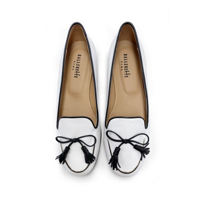 White leather moccasins with black bow